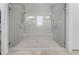 Spacious glass enclosed shower with dual shower heads and tiled walls at 323 S Esplanade, Alpharetta, GA 30009