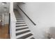 Modern staircase with dark wood steps, white risers, and a sleek, minimalist design at 323 S Esplanade, Alpharetta, GA 30009