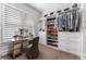 Organized walk-in closet with custom shelving, drawers, and a vanity area at 323 S Esplanade, Alpharetta, GA 30009