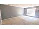 Comfortable bedroom featuring neutral carpet and natural light from the large window at 4701 Flat Shoals Rd # 25F, Union City, GA 30291