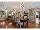 Spacious dining room featuring a stone fireplace, hardwood floors, and large windows offering ample natural light at 299 Saint Marys Nw Ln, Marietta, GA 30064