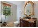 Half bath with granite countertop, custom cabinets, and ornate mirror at 299 Saint Marys Nw Ln, Marietta, GA 30064