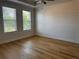 Comfortable bedroom featuring hardwood floors, recessed lighting, and large windows at 341 Bailey Walk, Alpharetta, GA 30009