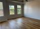 Spacious bedroom featuring hardwood floors, a ceiling fan, and ample natural light at 341 Bailey Walk, Alpharetta, GA 30009