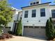 Charming townhome showcasing a well-maintained front yard and a convenient two-car garage at 341 Bailey Walk, Alpharetta, GA 30009