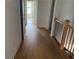 Upstairs hallway with hardwood floors and access to bedrooms at 341 Bailey Walk, Alpharetta, GA 30009