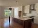 Bright, open kitchen with an island, stainless steel appliances, and plenty of cabinet space at 341 Bailey Walk, Alpharetta, GA 30009