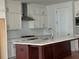 Modern kitchen featuring sleek white cabinets, stainless steel appliances, and a center island at 341 Bailey Walk, Alpharetta, GA 30009