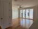 Bright living room with hardwood floors, recessed lighting, and sliding glass doors to patio at 341 Bailey Walk, Alpharetta, GA 30009