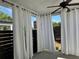 Relaxing covered patio space with white privacy curtains and a ceiling fan for warm weather comfort at 341 Bailey Walk, Alpharetta, GA 30009