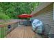 Spacious back deck with a red umbrella for shade at 1137 Eagles Nest Cir, Carrollton, GA 30116