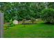 A lush backyard featuring a storage shed and mature trees at 1137 Eagles Nest Cir, Carrollton, GA 30116