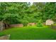 A large backyard featuring a wooden fence and mature trees at 1137 Eagles Nest Cir, Carrollton, GA 30116