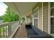 Spacious front porch with comfortable seating, perfect for enjoying the surrounding greenery and fresh air at 1137 Eagles Nest Cir, Carrollton, GA 30116