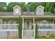 Attractive two-story home featuring a lovely front porch with white railings and inviting entry steps at 1137 Eagles Nest Cir, Carrollton, GA 30116