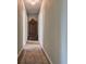 Hallway with carpet flooring and decorative curio cabinet in the center at 1137 Eagles Nest Cir, Carrollton, GA 30116