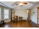 Cozy living room featuring hardwood floors, a grandfather clock, and comfortable seating, perfect for relaxation at 1137 Eagles Nest Cir, Carrollton, GA 30116