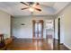 Bright living room with hardwood floors and ceiling fan, perfect for gatherings and relaxation at 1137 Eagles Nest Cir, Carrollton, GA 30116