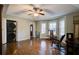 Spacious room with hardwood floors, ceiling fan, bay windows, and laundry closet near the entrance at 1137 Eagles Nest Cir, Carrollton, GA 30116