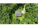 Aerial view of brick home nestled in a lush, green wooded lot at 1950 Lower Burris Rd, Canton, GA 30114