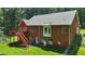 Rear exterior of brick home featuring a wooden deck and yard at 1950 Lower Burris Rd, Canton, GA 30114