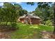 View of brick home with a spacious yard and mature trees at 1950 Lower Burris Rd, Canton, GA 30114