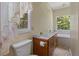 Bright bathroom with a double sink vanity, and lace curtains over the windows, and a soaking tub at 1950 Lower Burris Rd, Canton, GA 30114