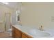 Bathroom featuring double sinks, a walk-in shower, and neutral colored walls at 1950 Lower Burris Rd, Canton, GA 30114