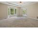 Spacious carpeted bedroom with a ceiling fan, bay window, and mirrored closet doors at 1950 Lower Burris Rd, Canton, GA 30114