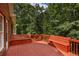 A spacious deck with built-in bench seating overlooks a lush, green backyard, perfect for outdoor entertaining at 1950 Lower Burris Rd, Canton, GA 30114