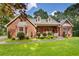 Charming brick home with a manicured lawn and mature trees at 1950 Lower Burris Rd, Canton, GA 30114