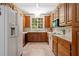 Galley kitchen featuring oak cabinets, white appliances, and a view to the backyard at 1950 Lower Burris Rd, Canton, GA 30114
