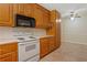 Kitchen featuring oak cabinets, and white appliances at 1950 Lower Burris Rd, Canton, GA 30114