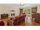 Living room featuring a fireplace, built-in shelving, hardwood floors, and a cozy seating area at 1950 Lower Burris Rd, Canton, GA 30114