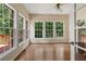 Bright sunroom with wood floors and multiple windows providing natural light and outdoor views at 1950 Lower Burris Rd, Canton, GA 30114