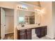 Bathroom featuring double sinks, a large mirror, and a tiled walk-in shower adjacent to a soaking tub at 3677 Trillium Forest Dr, Snellville, GA 30039