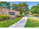 Stone community sign for Trillium Forest with lush landscaping and sidewalk at 3677 Trillium Forest Dr, Snellville, GA 30039