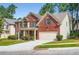 Charming two-story brick home with manicured lawn and a two-car garage at 3677 Trillium Forest Dr, Snellville, GA 30039