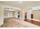 Open living room with neutral carpet and arched doorways to dining and entry at 3677 Trillium Forest Dr, Snellville, GA 30039