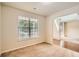 Cozy room with carpet flooring, a large window, and an archway to the foyer at 3677 Trillium Forest Dr, Snellville, GA 30039