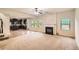 Open concept living room with fireplace, adjacent to a modern kitchen with stainless steel appliances at 3677 Trillium Forest Dr, Snellville, GA 30039