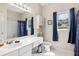 Bathroom with blue curtains, a mirror and sink and toilet at 3072 Oaktree Ln, Duluth, GA 30096