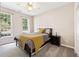 Cozy bedroom featuring carpeted floors, natural light from the windows, and a comfortable bed at 3072 Oaktree Ln, Duluth, GA 30096