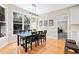 Bright dining area featuring a modern light fixture, hardwood floors, and views of the landscaped backyard at 3072 Oaktree Ln, Duluth, GA 30096