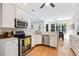 Modern kitchen with white cabinetry, stainless steel appliances, and hardwood floors at 3072 Oaktree Ln, Duluth, GA 30096
