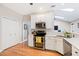 Well-lit kitchen with white cabinets, modern appliances, and a cozy breakfast nook beyond at 3072 Oaktree Ln, Duluth, GA 30096