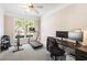 Well-lit office featuring neutral tones, a ceiling fan, and space for exercise equipment at 3072 Oaktree Ln, Duluth, GA 30096