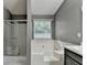Bathroom featuring a soaking tub, separate shower, and a window providing natural light at 3625 Ennfield Lane Ln, Duluth, GA 30096