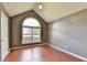 Bedroom features a high ceiling, large window, and wood flooring at 3625 Ennfield Lane Ln, Duluth, GA 30096