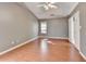 This spacious bedroom features wood floors, a ceiling fan, and a neutral paint palette at 3625 Ennfield Lane Ln, Duluth, GA 30096